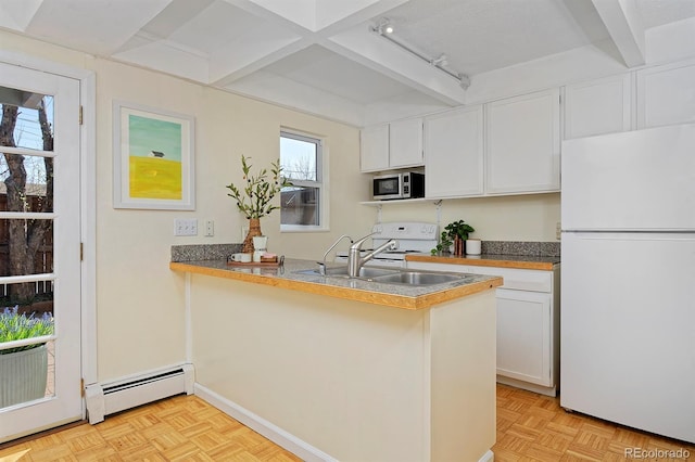 kitchen featuring baseboard heating, stainless steel microwave, beam ceiling, and freestanding refrigerator