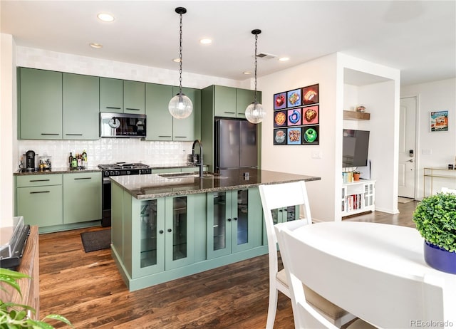 3412 Valentia St, Denver, CO 80238 - kitchen featuring appliances with stainless steel finishes, green cabinetry, tasteful backsplash, hanging light fixtures, and recessed lighting