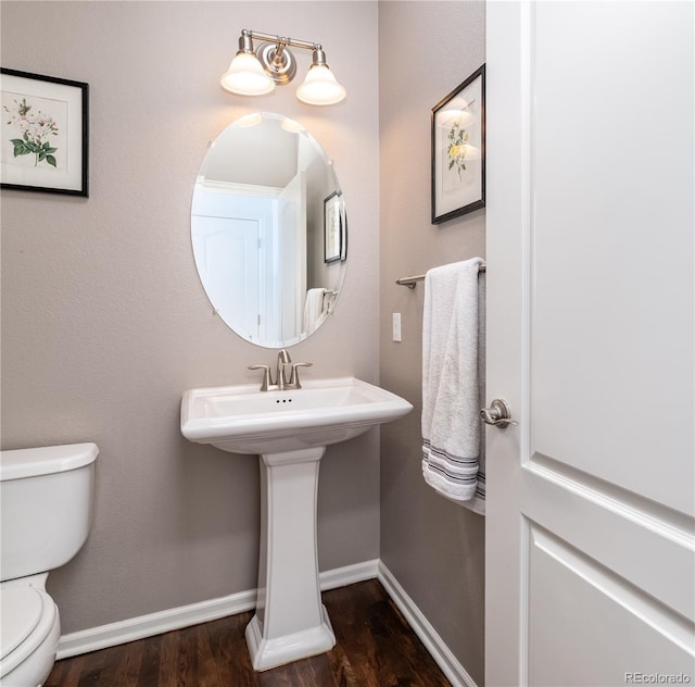 3412 Valentia St, Denver, CO 80238 - half bath featuring toilet and wood finished floors