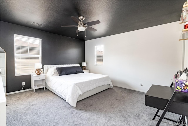 3412 Valentia St, Denver, CO 80238 - carpeted bedroom featuring a textured ceiling, arched walkways, and ceiling fan