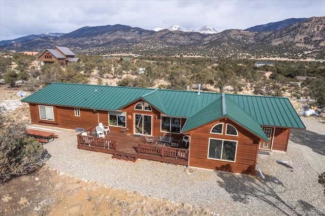 view of front of property with a deck with mountain view