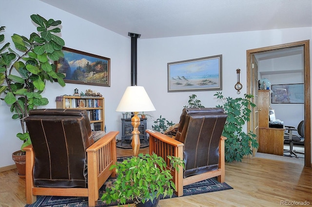 living area with vaulted ceiling and light wood-type flooring