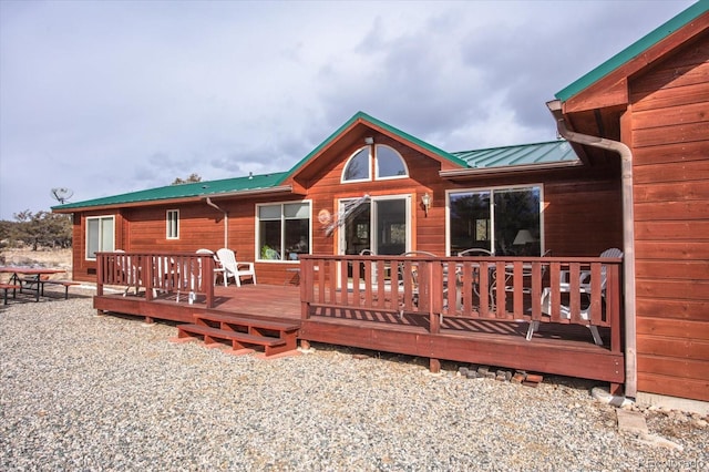 rear view of property featuring a wooden deck