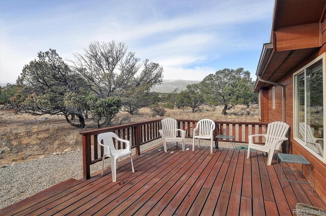 wooden deck with a mountain view