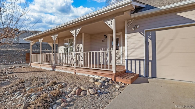 property entrance featuring a garage and a porch