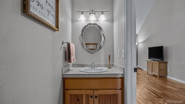 bathroom with vanity and hardwood / wood-style flooring