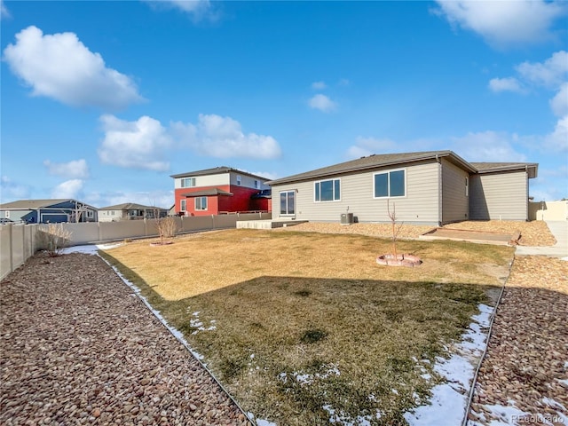 back of house featuring cooling unit and a yard