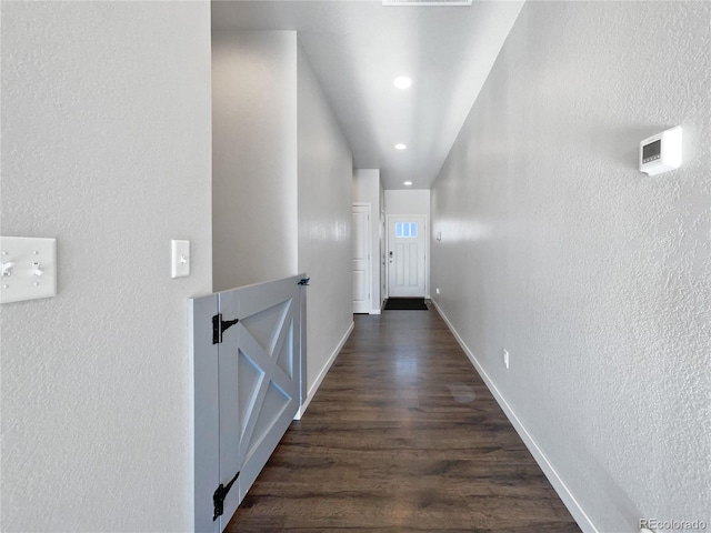 corridor with dark hardwood / wood-style flooring