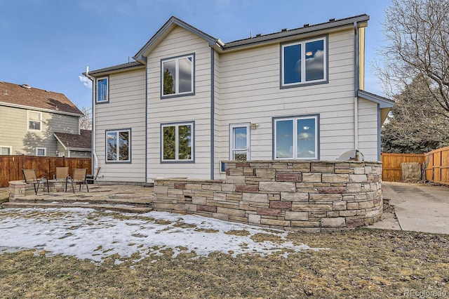 rear view of property with a patio area and fence