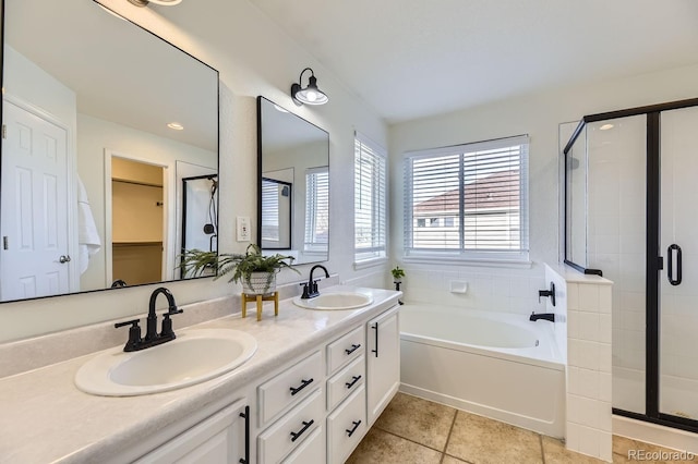 bathroom featuring a stall shower and a sink