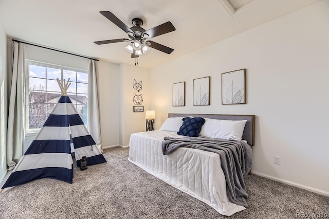 carpeted bedroom with a ceiling fan and baseboards