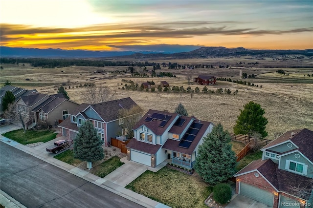 drone / aerial view featuring a residential view, a rural view, and a mountain view