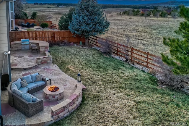 view of yard with an outdoor living space with a fire pit, a patio, and fence