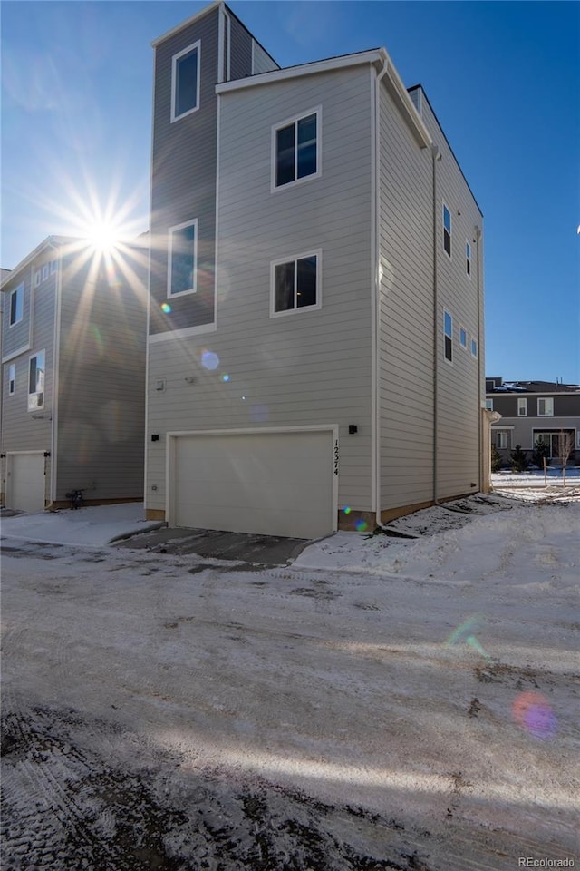 back of property with a garage