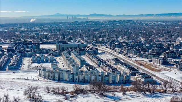 snowy aerial view with a mountain view