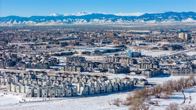 snowy aerial view featuring a mountain view