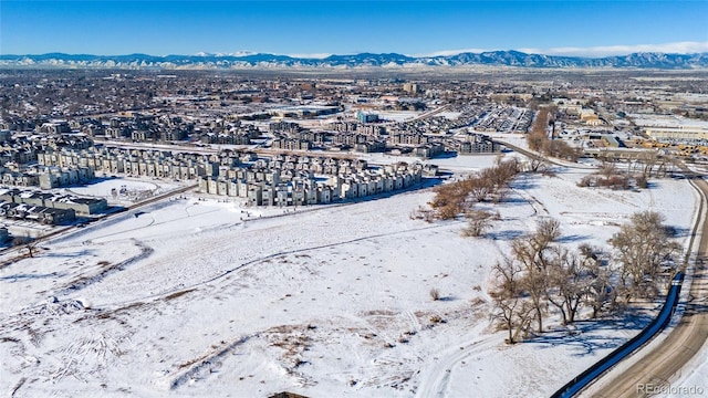 snowy aerial view featuring a mountain view