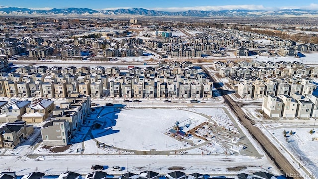 snowy aerial view featuring a mountain view