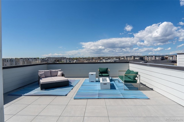 view of patio with an outdoor living space with a fire pit