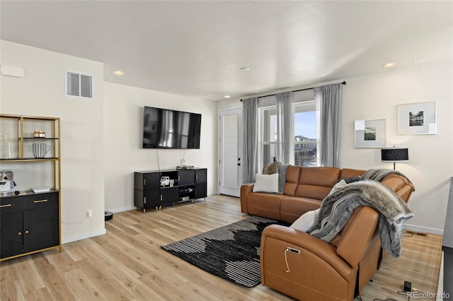 living room with baseboards, recessed lighting, light wood-style flooring, and visible vents