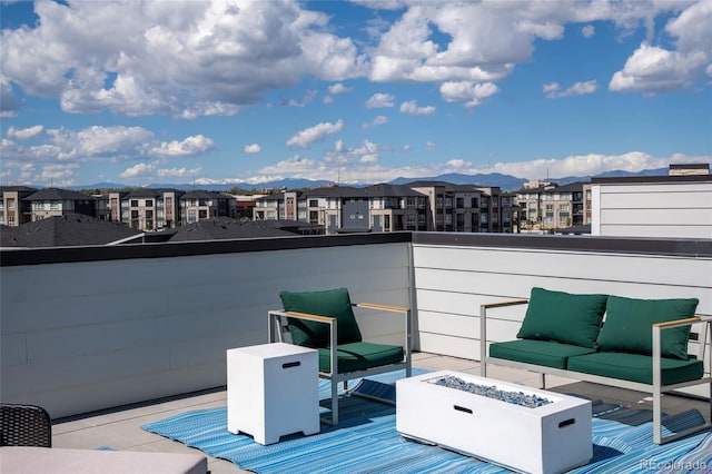 wooden deck with a residential view, a mountain view, and a fire pit