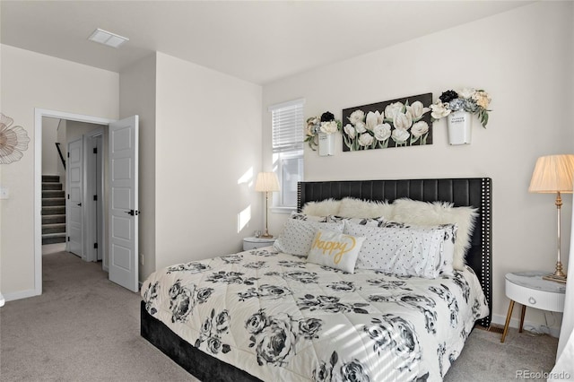 bedroom featuring visible vents, carpet flooring, and baseboards