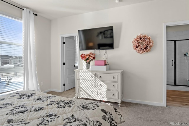 bedroom with baseboards, multiple windows, and light carpet