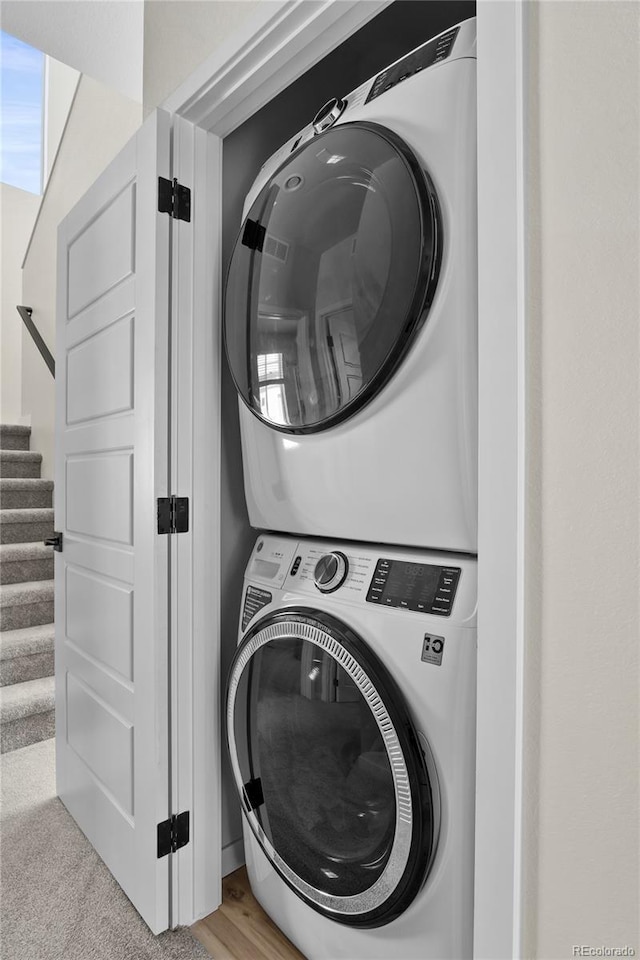 laundry area featuring laundry area and stacked washer and dryer