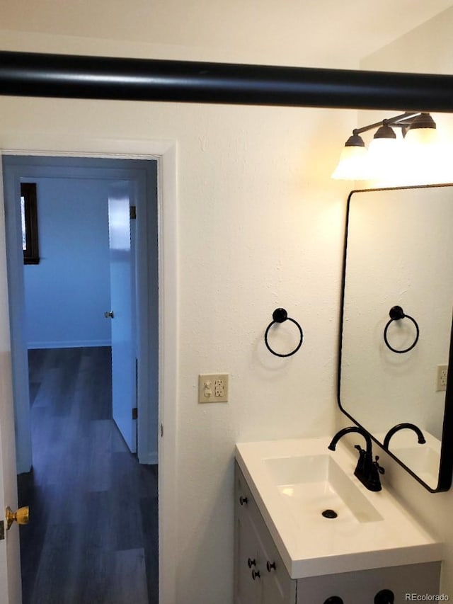 609 S 1st Ave, Brighton, CO 80601 - bathroom with vanity and wood finished floors