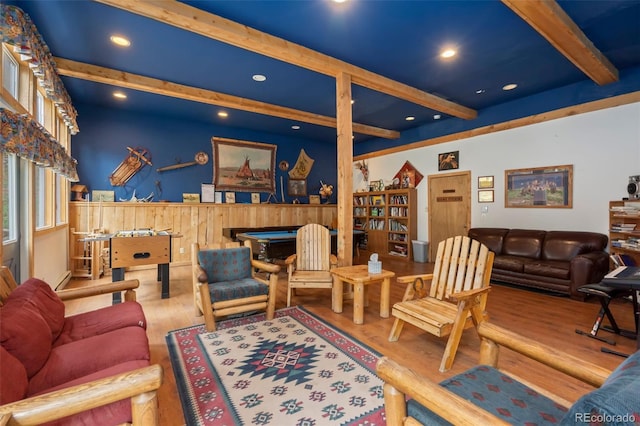 living room featuring pool table, beam ceiling, and hardwood / wood-style floors