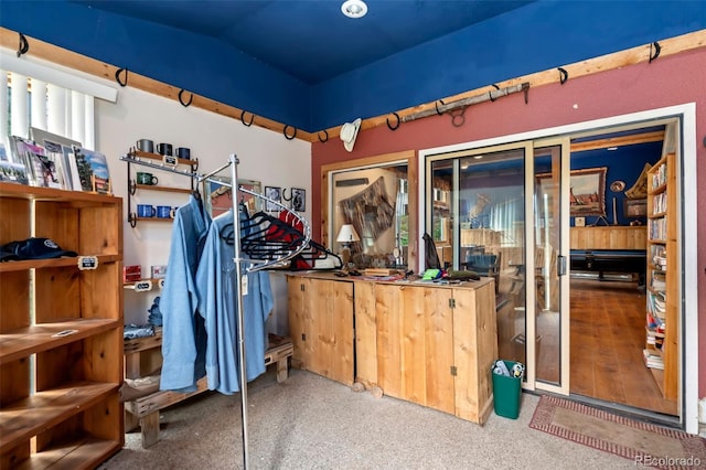 walk in closet featuring wood-type flooring and vaulted ceiling