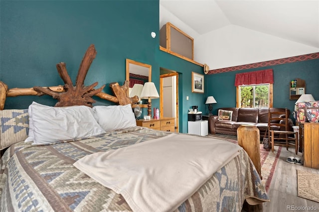 bedroom featuring wood-type flooring and lofted ceiling