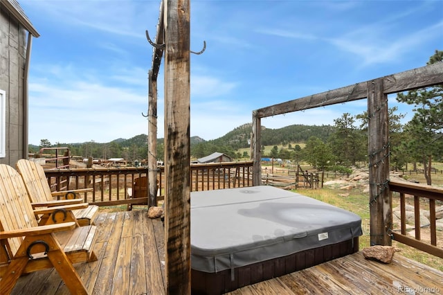 wooden deck featuring a covered hot tub