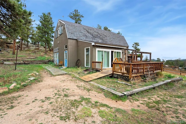 rear view of house with a wooden deck