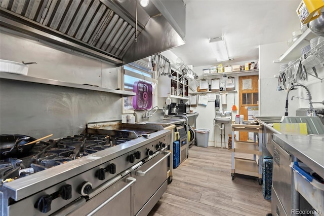 kitchen featuring high end stove and light hardwood / wood-style flooring