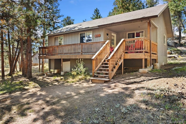 rear view of property featuring a deck