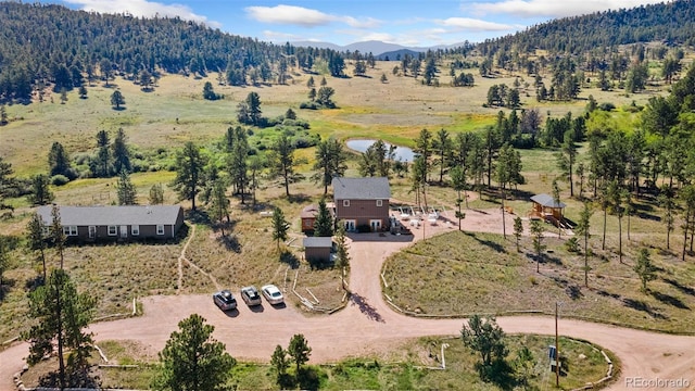 drone / aerial view featuring a mountain view and a rural view