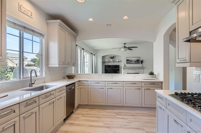 3525 Rinn Valley Dr, Longmont, CO 80504 - kitchen with appliances with stainless steel finishes, recessed lighting, light wood-type flooring, arched walkways, and ceiling fan