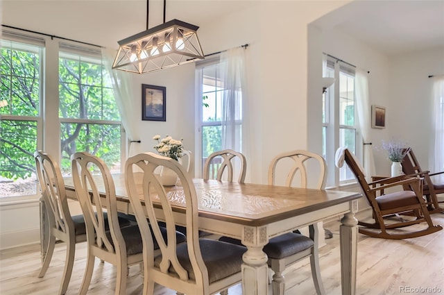 3525 Rinn Valley Dr, Longmont, CO 80504 - dining area featuring light wood finished floors and a chandelier