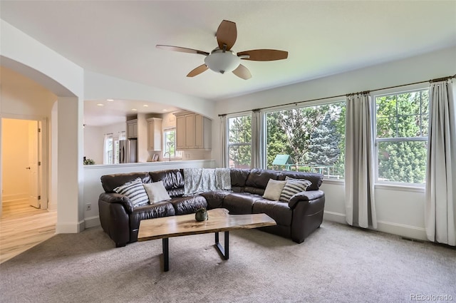 3525 Rinn Valley Dr, Longmont, CO 80504 - living area with arched walkways, light carpet, ceiling fan, and recessed lighting