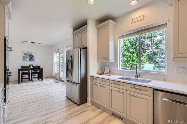 3525 Rinn Valley Dr, Longmont, CO 80504 - kitchen with appliances with stainless steel finishes, backsplash, recessed lighting, and plenty of natural light