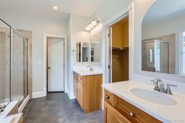 3525 Rinn Valley Dr, Longmont, CO 80504 - bathroom featuring a shower stall, two vanities, tile patterned floors, and recessed lighting