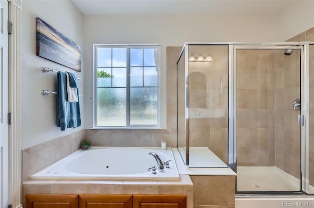 3525 Rinn Valley Dr, Longmont, CO 80504 - full bathroom featuring plenty of natural light, a jetted tub, and a shower stall