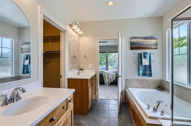 3525 Rinn Valley Dr, Longmont, CO 80504 - ensuite bathroom featuring two vanities, a whirlpool tub, and recessed lighting