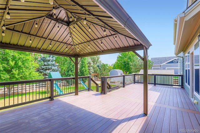 3525 Rinn Valley Dr, Longmont, CO 80504 - wooden terrace featuring a playground, a gazebo, and a storage unit