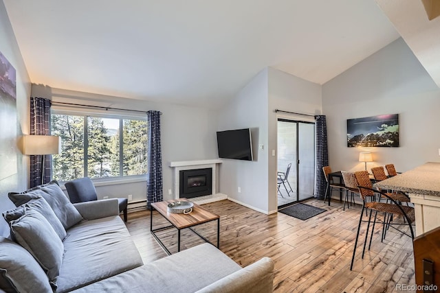 living room featuring high vaulted ceiling, a baseboard radiator, and light hardwood / wood-style floors