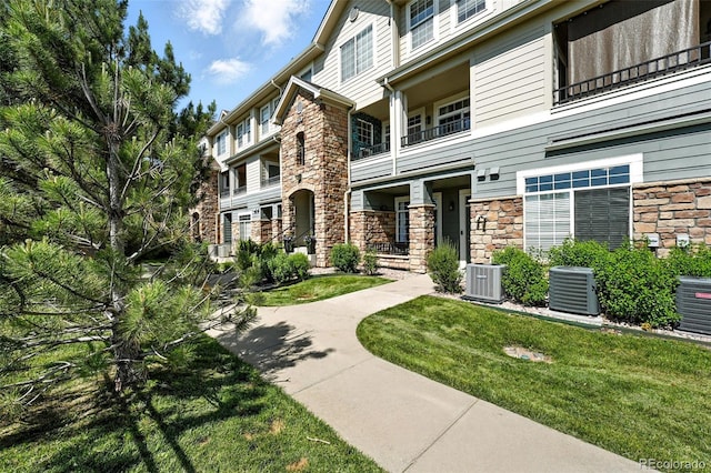 474 Black Feather Loop Unit 406, Castle Rock, CO 80104 - view of front of property with stone siding and a front lawn