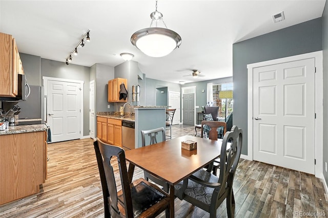 474 Black Feather Loop Unit 406, Castle Rock, CO 80104 - dining area with light wood-style floors, a ceiling fan, and track lighting