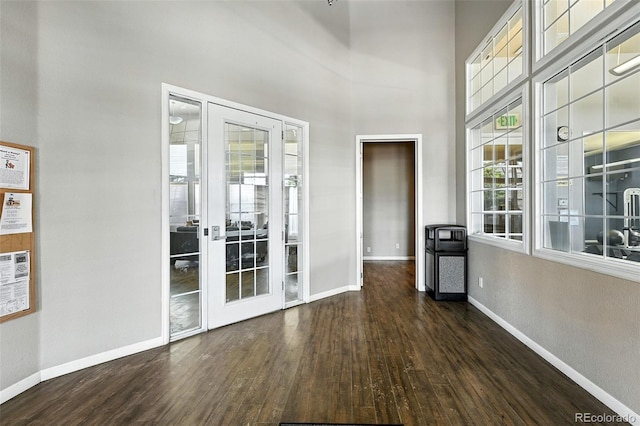 474 Black Feather Loop Unit 406, Castle Rock, CO 80104 - empty room with wood finished floors, french doors, and a towering ceiling