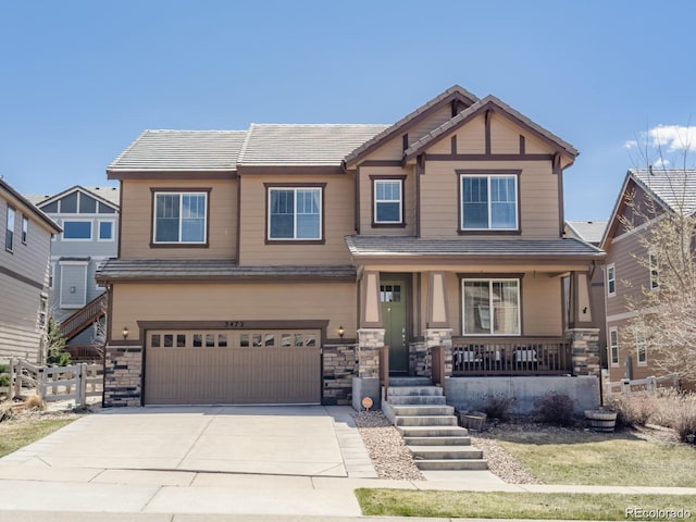 3472 Harvard Pl, Broomfield, CO 80023 - craftsman house featuring covered porch, a garage, stone siding, and driveway